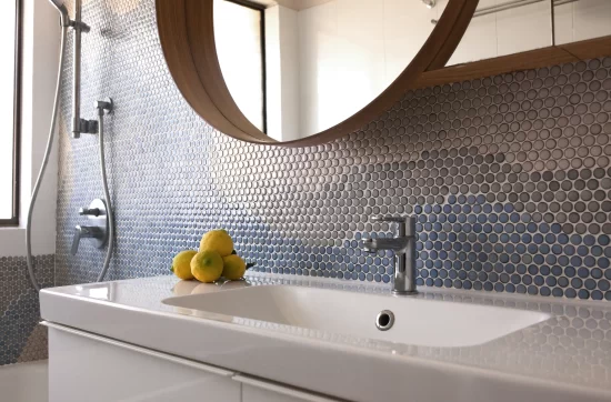 Bathroom sink displayed with decorative wall tiles