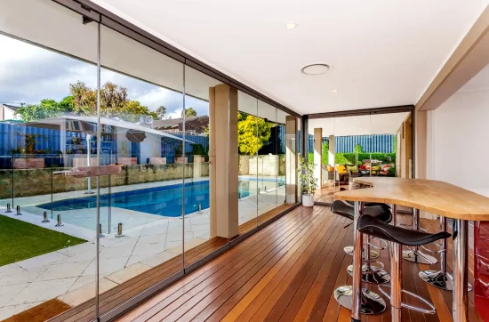 Indoors view looking outside at a swimming pool