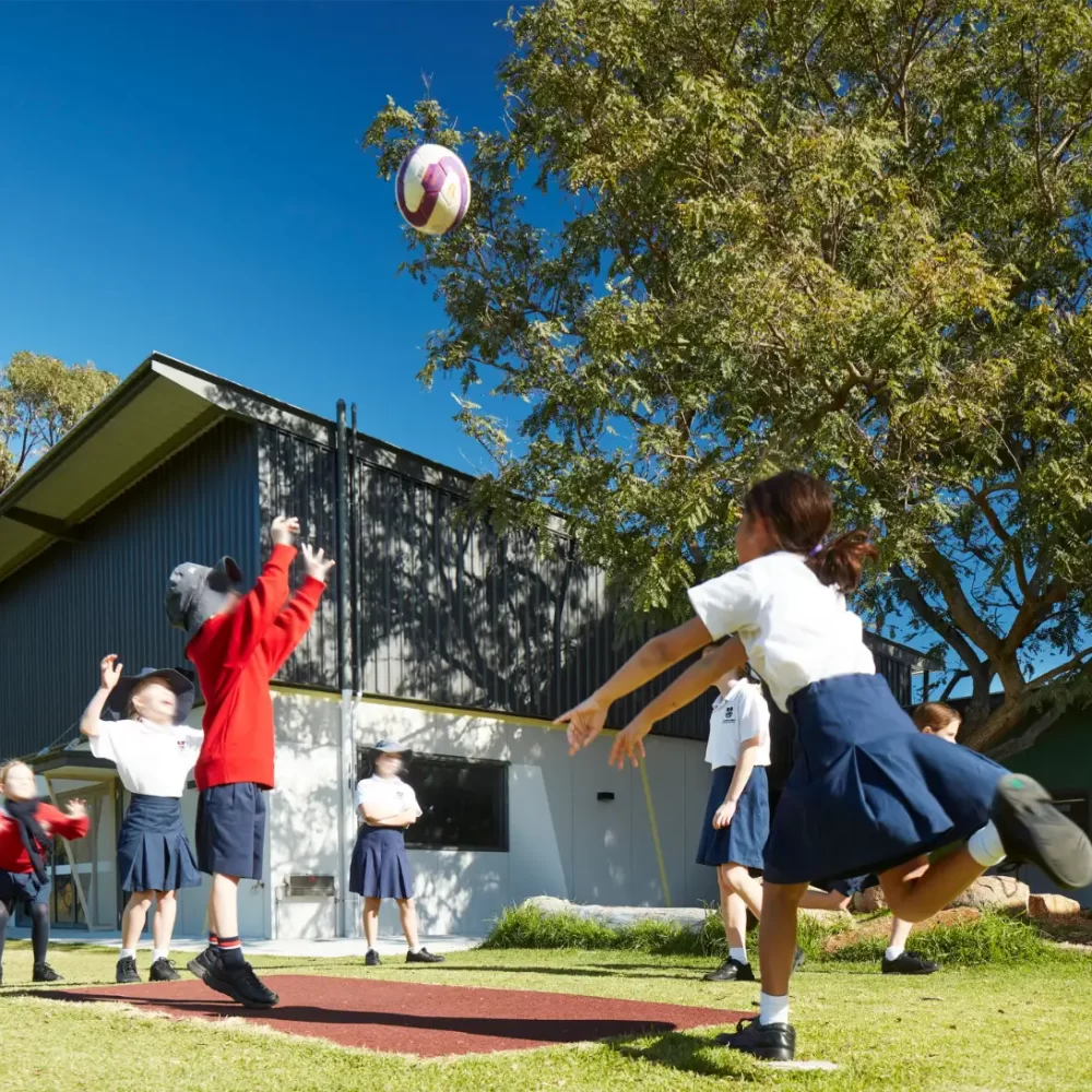 Children playing catch outside St Stephens Primary