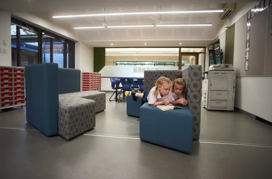 Children reading a book on seat